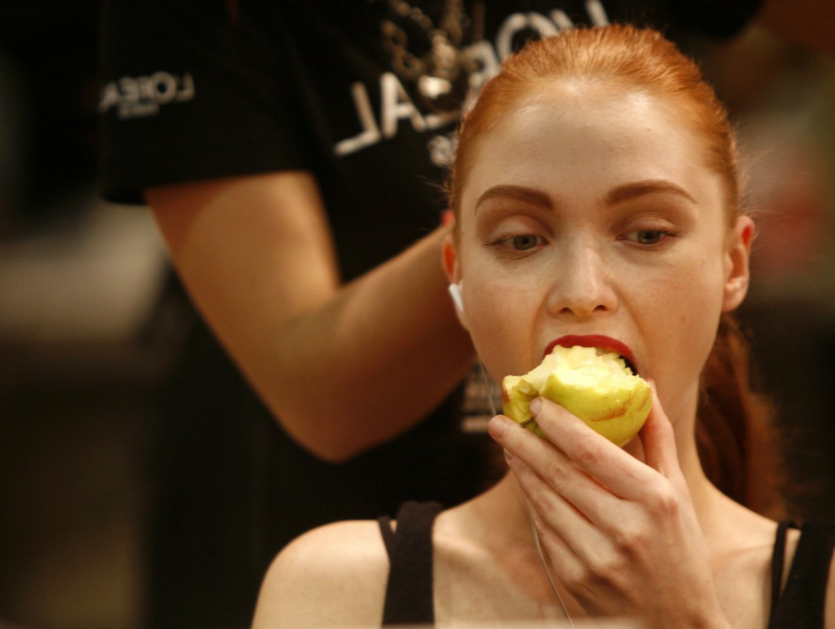 a-redheaded-model-enjoys-an-apple-as-her-hair-is-styled-backstage-at-antonio-pernas-madrid-show.jpg